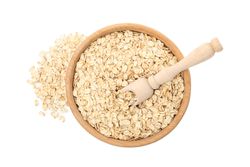 Bowl and scoop with oatmeal flakes isolated on plain background