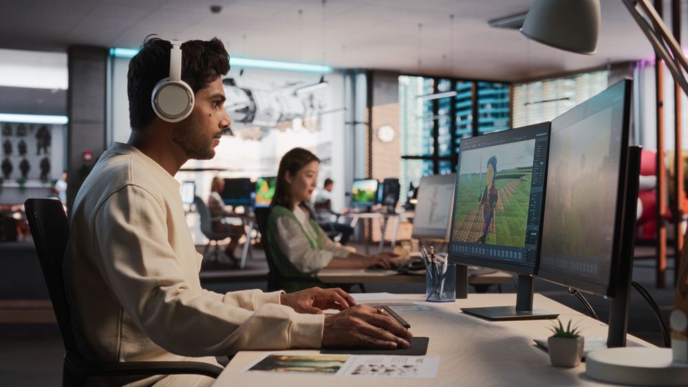 Indian Male Game Designer Using Desktop Computer With 3D Modelling Software To Design Unique Characters And World For Immersive RPG Video Game.