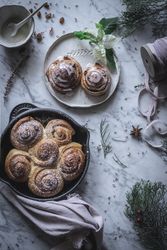 Herbs and napkin near cinnamon rolls