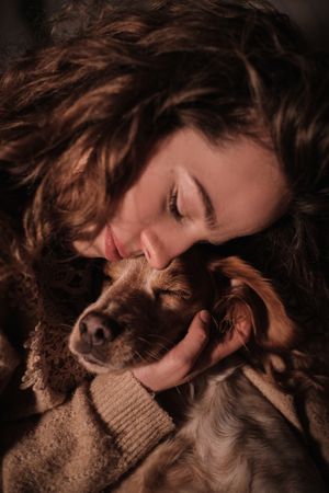 Smiling beautiful woman hugging dog