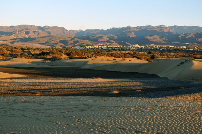 Picturesque sandy valley with distant exotic town