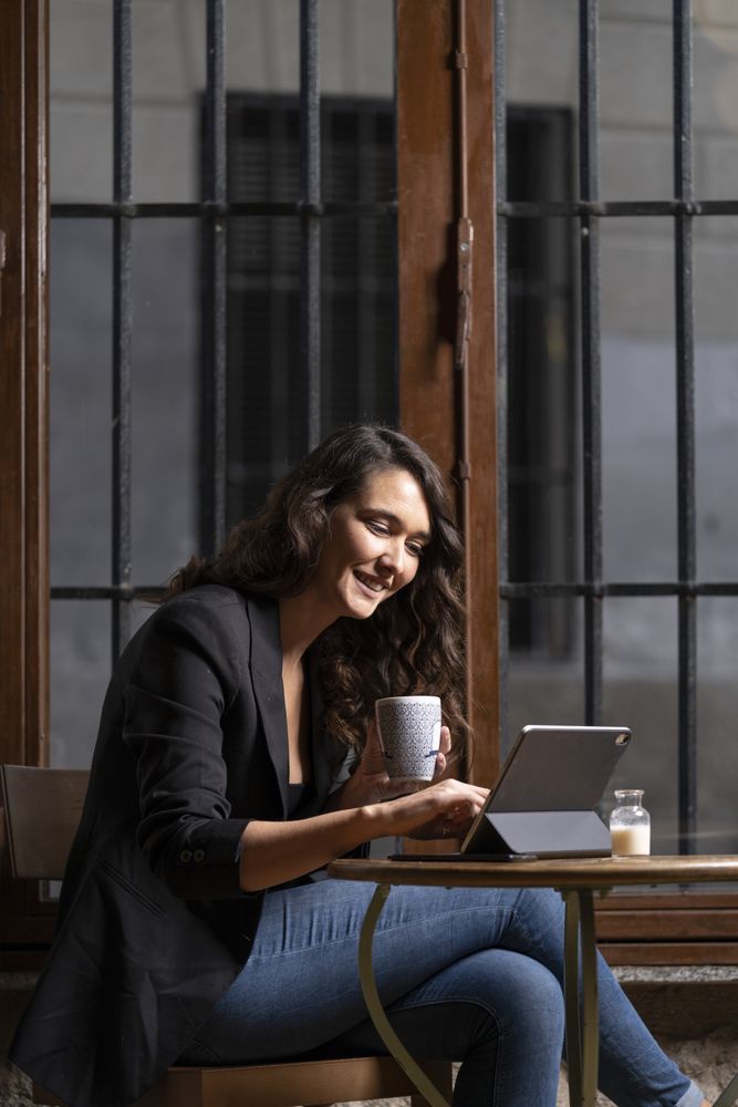 Young female using digital tablet in cafe