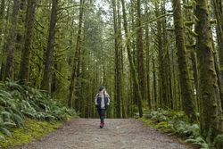 Mature woman walking on a path in the woods