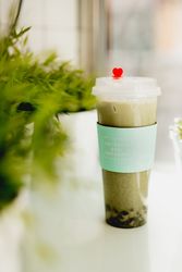 Cup of hot matcha tea in Asian cafe