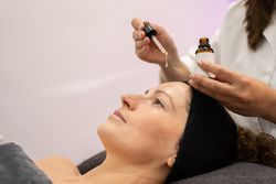 Side view of client having product dripped on forehead