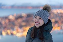 Joyful millennial woman enjoying view of night city