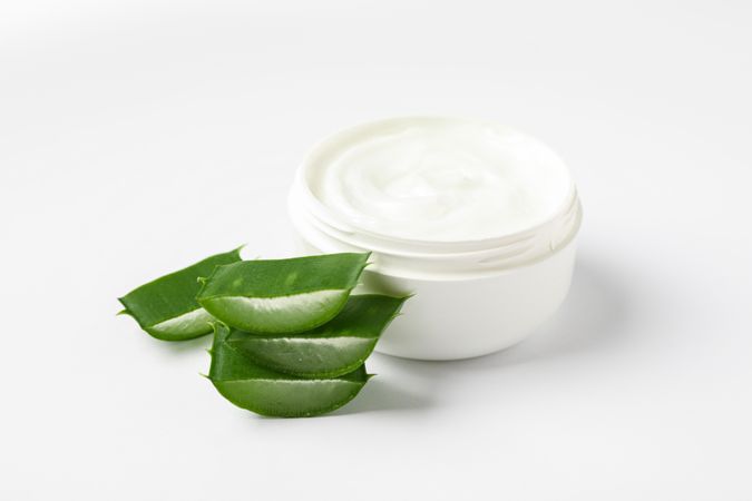 Composition with natural treatment accessories on plain background, space for text. Aloe vera