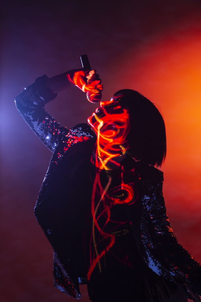 Stylish woman singing on stage