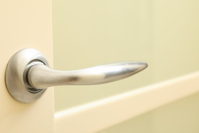 Metal handle of door in room