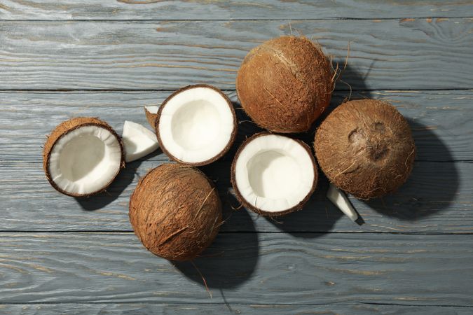 Coconut on wooden background, top view. Tropical fruit