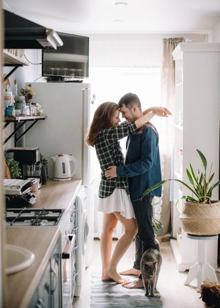 Man and woman hugging at home