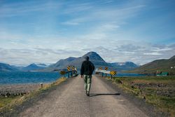 Man walking towards bridge
