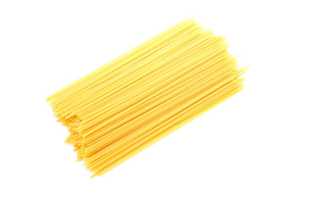 Pasta isolated on light background, top view. Uncooked whole wheat pasta
