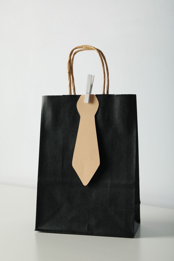 The concept of a gift for father's day, on a plain background.