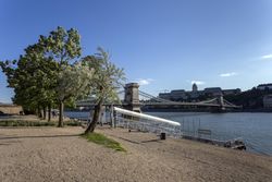 Chain Bridge in Budapest photographed from the shore on clear day