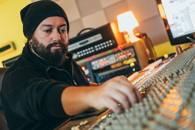 Man in a equalizer instrument in a studio