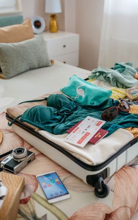 Open woman suitcase prepared for vacation