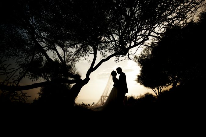 Marriage of woman and man embracing in darkness