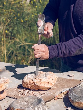 Anonymous male working with stone