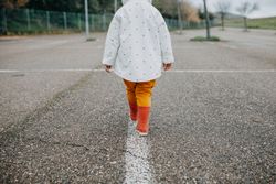Back view of young child walking away