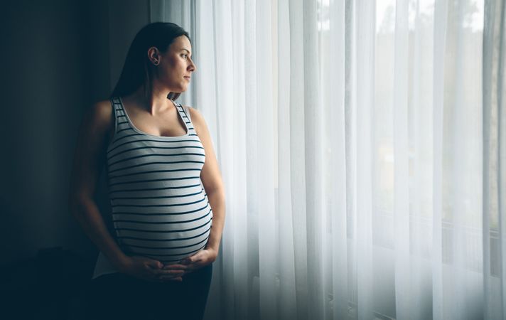 Pregnant woman holding her belly