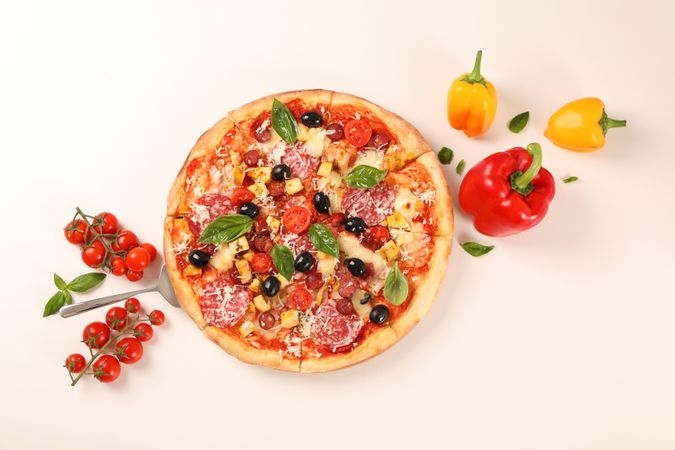 Flat lay. Tasty pizza and ingredients on plain background, copy space