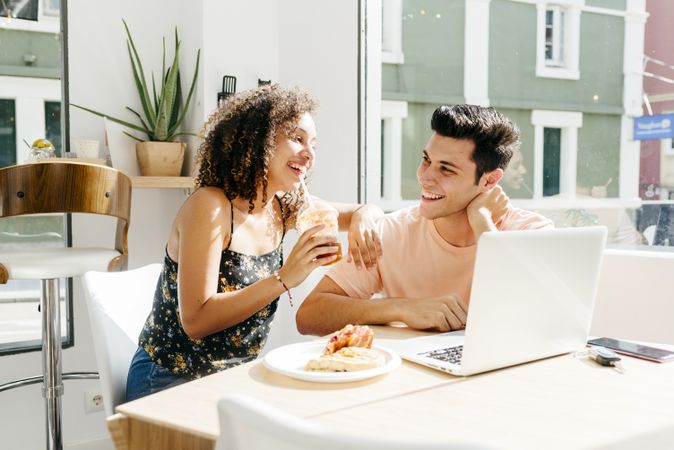 Happy diverse couple resting in restaurant