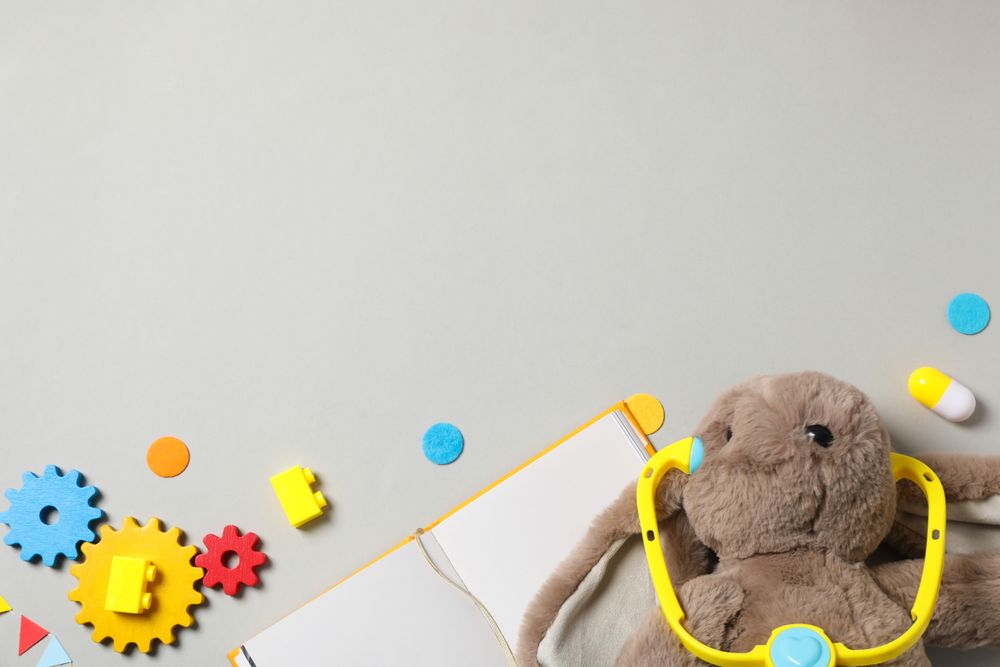 A children's book with toys on a light background.
