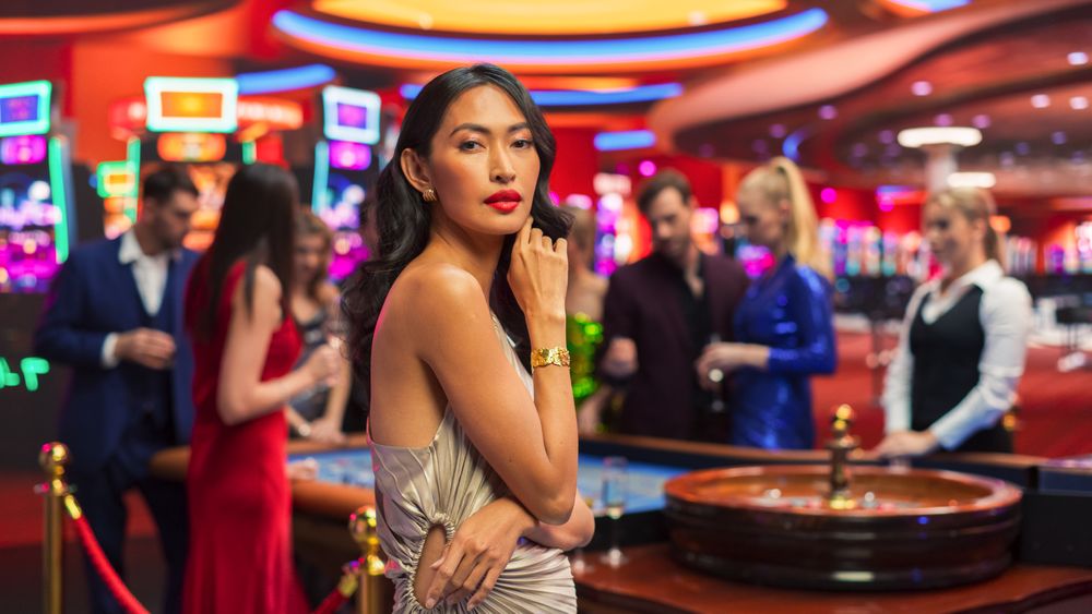 Commercial Footage Portrait of a Sophisticated Asian Woman in a Stunning Dress Posing and Looking at Camera in a Glamorous Casino