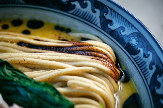 Tasty ramen with cooked noodles in broth