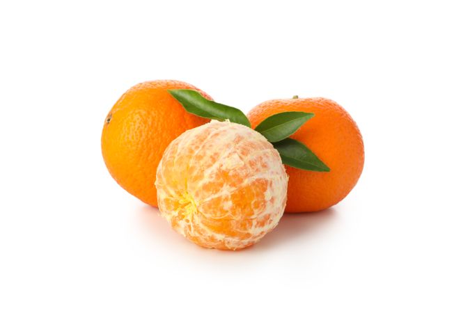 Group of ripe mandarins isolated on light background