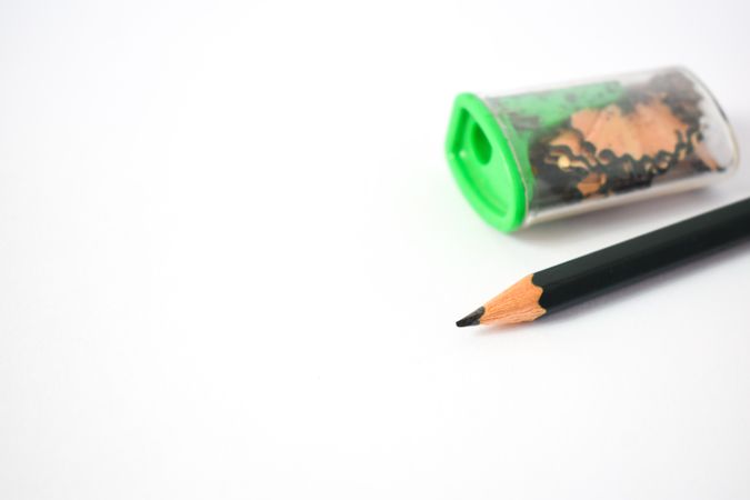 Sharpened pencil next to sharpener on table with copy space