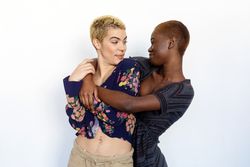 Female couple holding each other in studio space