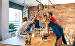 Businesspeople celebrating a success high-fiving