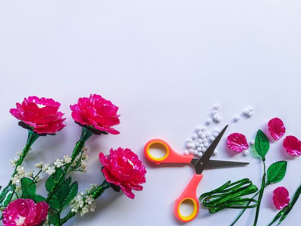 DIY Plastic Flower Craft Materials on Plain Background