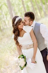 Newlyweds being affectionate in poplar forest