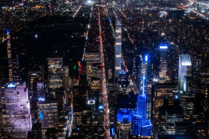 Scenic Aerial New York City View of Downtown Manhattan Architecture. High Angle Night Shot of the Business District from a Helicopter. Cityscape with Office Buildings and Busy Traffic on Streets