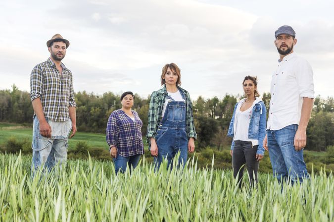 Group of people standing at countryside while looking at camera