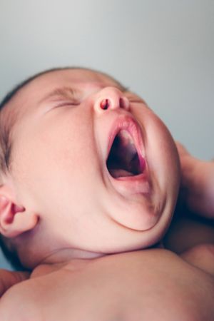 Newborn baby girl yawning