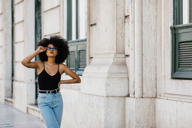Cheerful Black female in dark sunglasses