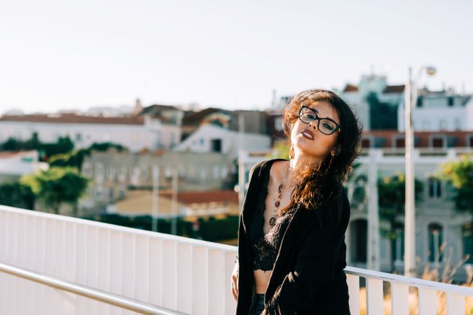 Trendy female standing on urban background