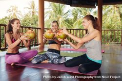Group of female having coconut juice during break at yoga class 5pYkA4