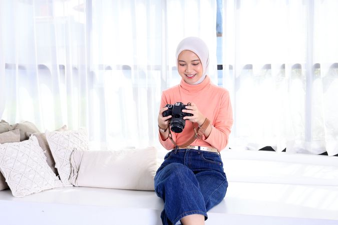 Young Muslim Women in Beautiful Hijab Holding the Camera and Looking into it