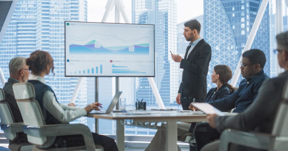Office Conference Room Meeting Presentation: CEO Talks, Uses TV to Show Company Growth with Big Data Analysis