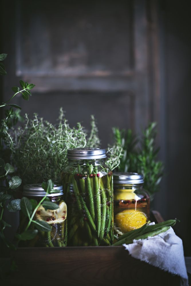 Fresh green vegetables with fruits and glass jars