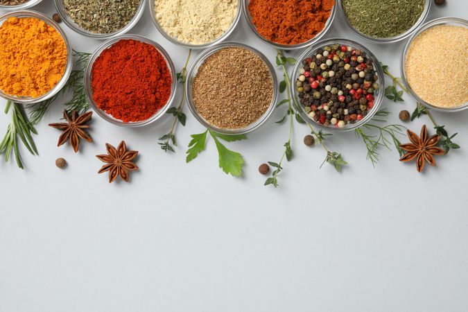 Top view close up of bowls of spice in rows with copy space