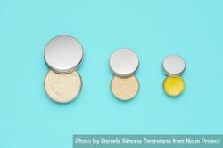 Natural cosmetics in metal cans, isolated on a blue background 41mXp4
