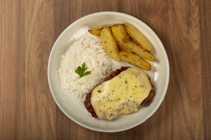 Parmigiana steak with rice and roasted potatoes. Typical Brazilian dish.
