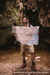 Skilled hiker using a map to find the route to the destination 5XmZr4