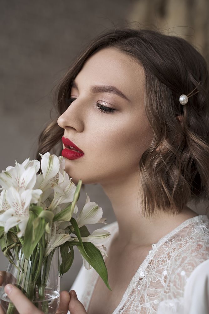 woman with red lips holding white flowers and dreaming